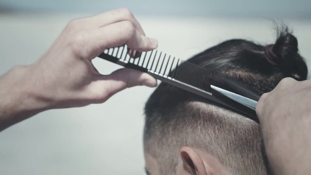 Male haircut outdoors. Stylish haircut man. Close up of barber haircut. Male hipster hairstyle. Hipster haircut. Male hairdressing. Man hairstyle. Stylish hair cut
