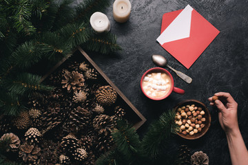 pine cones, cup of cacao and envelope