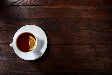 Cup of tea on a wooden background top view.