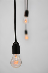 Incandescent lamp on wire. Selective focus photo.