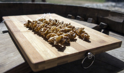 Peeled walnuts on a wooden board prepared for cooking churchhela.