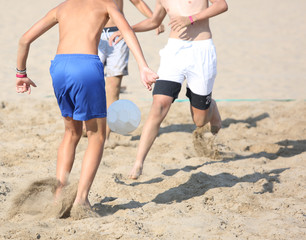athletes during the beach soccer game on the sand