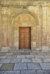 Front door with wooden ornate and antique wall
