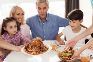 Turkey for Thanksgiving. Family preparing for a festive dinner meeting at the table