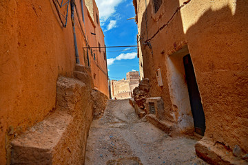 street in the old part of the city in Morocco, the houses built their clay in a saturated color