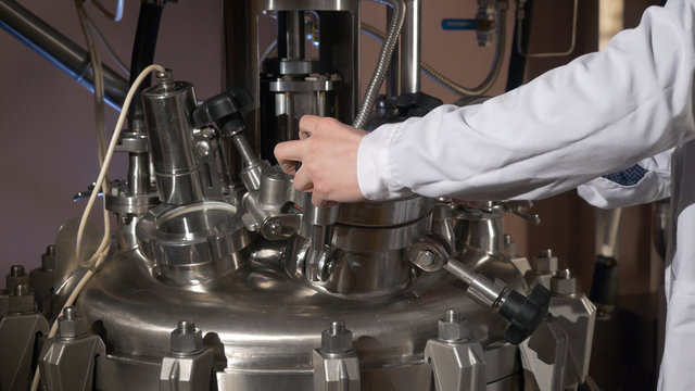 Medical specialist. Chemist opens the equipment.