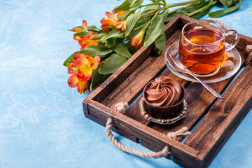 Photo of breakfast with cupcake, orange flowers