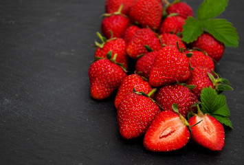 Strawberries on a black stone background