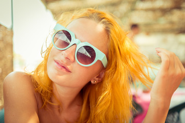 Red haired woman in beach cafe