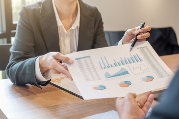 Business concept. Business people discussing the charts and graphs showing the results of their successful teamwork.
