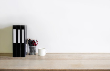 Work space Mock up : wood tabletop with files folder, coffee cup and pencils .wood desk with copy space for products display montage.