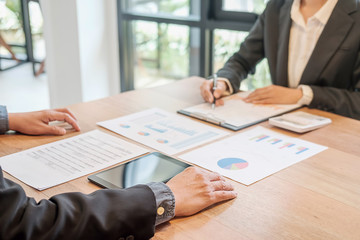 Business concept. Business people discussing the charts and graphs showing the results of their successful teamwork.