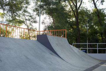 Empty concrete skatepark plaza background 