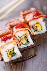 Sushi rolls served on wooden slate