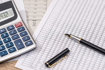 Naklejka na ściany i meble business concept - financial reports with calculator, pen.