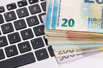 euro money on laptop. close up