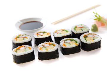 Futomaki sushi , Japanese roll rice egg avocado cucumber and caviar isolated in white background