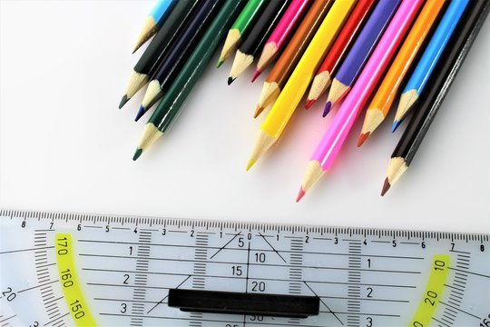 An image of a triangle ruler and a pen - office, school