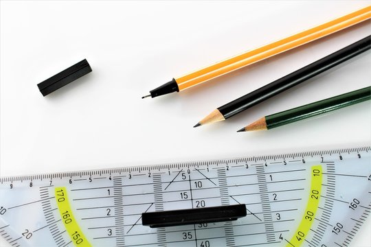 An image of a triangle ruler and a pen - office, school