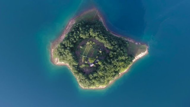 Drone aerial shoot of small island on Ramsko Jezero lake - a tourist destination near Prozor, Bosnia and Herzegovina
