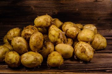 Pile of the young potato on wooden table