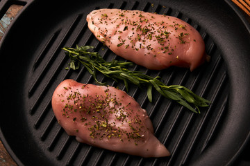 Raw chicken breast fillet with rosemary