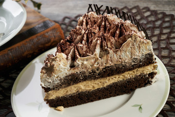 Cup of tea and Delicious chocolate cake with whipped cream