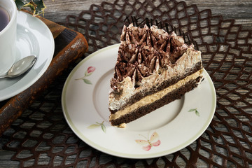 Cup of tea and Delicious chocolate cake with whipped cream