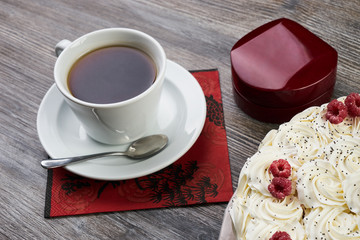 Traditional tasty christmas white cake and cup of black tea