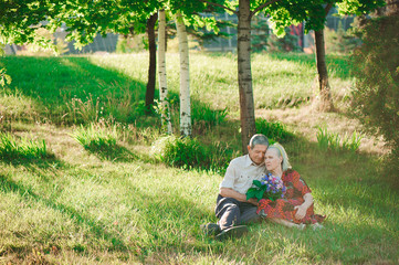 Naklejka na ściany i meble happy and very old people sitting in the park