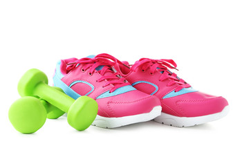 Sport shoes with dumbbells isolated on a white background