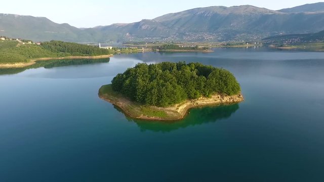 Drone aerial shoot of small island on Ramsko Jezero lake - a tourist destination near Prozor, Bosnia and Herzegovina