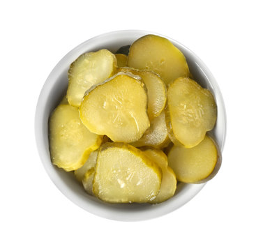 Bowl with pickled cucumber slices on white background