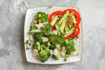 Plate with broccoli salad on table