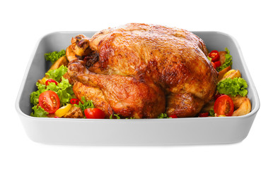 Baking dish with roasted turkey and vegetables on white background