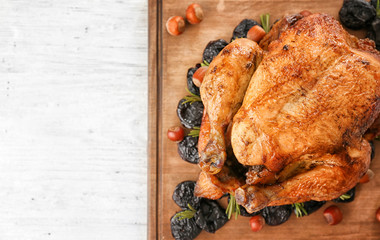 Roasted turkey with prune and nuts on wooden board