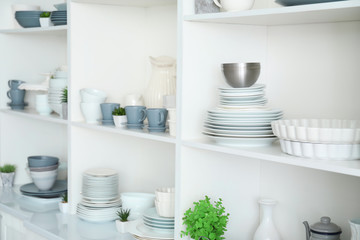 White storage stand with ceramic dishware in kitchen