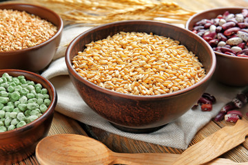 Bowls with different grains on kitchen table