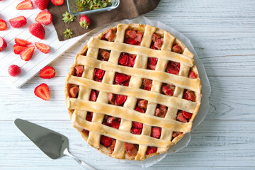 Strawberry rhubarb pie on wooden table