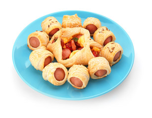 Plate with delicious pastry with sausage on white background
