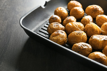 Many baked potatoes on grill pan
