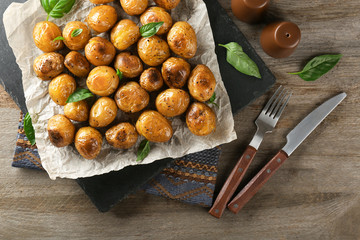 Many baked potatoes on slate plate