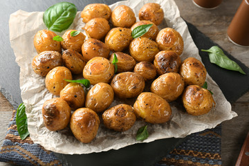 Many baked potatoes on slate plate