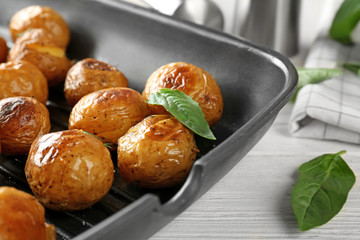 Many baked potatoes on grill pan
