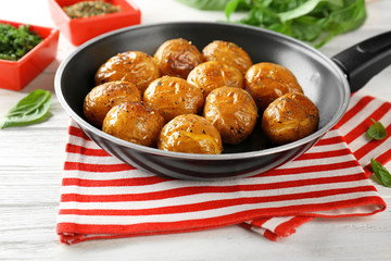 Many baked potatoes on frying pan