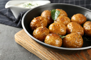 Many baked potatoes on frying pan