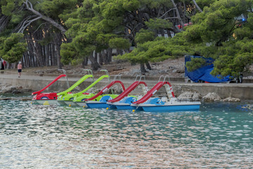 parked pedal boats with slides at sea shore