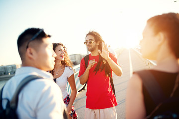 Group of positive young people looking for a new destination in the sunny day.