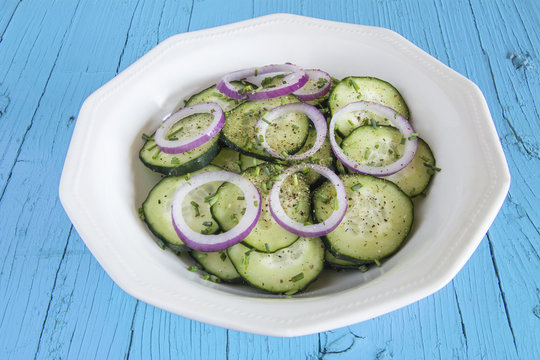 
Cucumber salad with red onion and ground pepper.