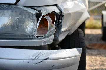 Front view of damaged silver car after accident. 